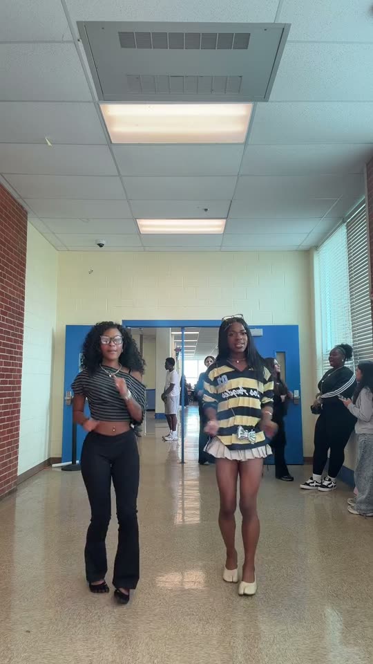 Two people dancing in hallway