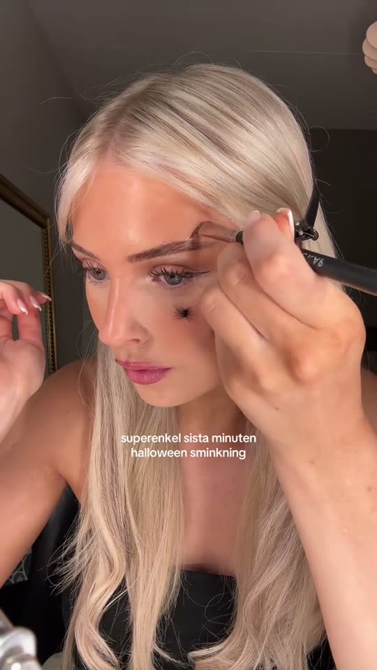 Applying spider Halloween makeup