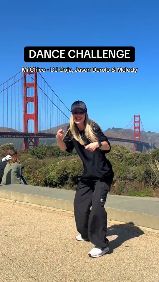 Woman dances by Golden Gate
