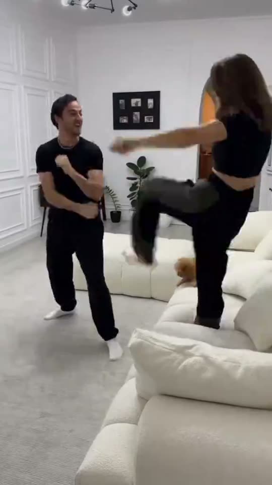 Woman kicks man playfully