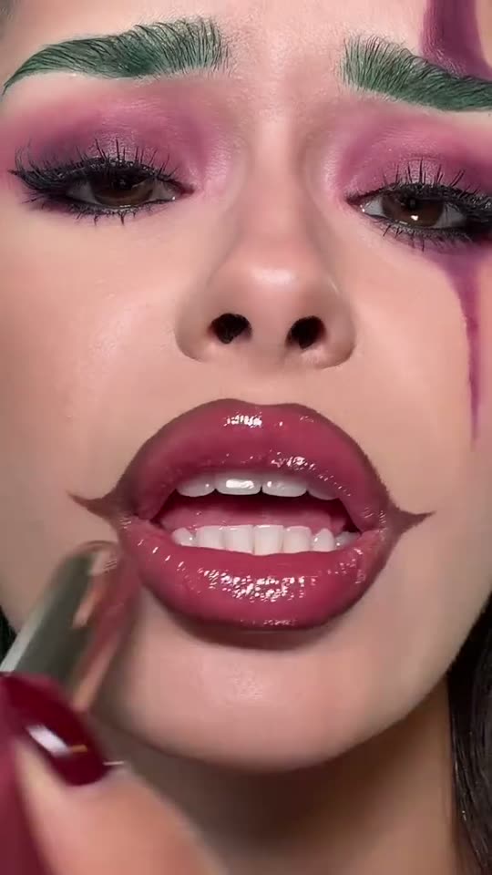 Applying Joker-inspired lip gloss