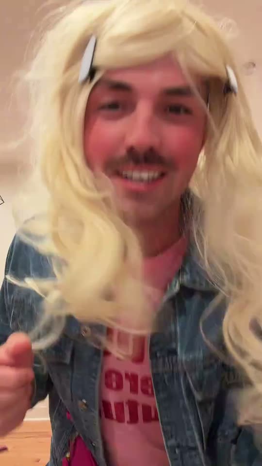 Man in wig and denim jacket