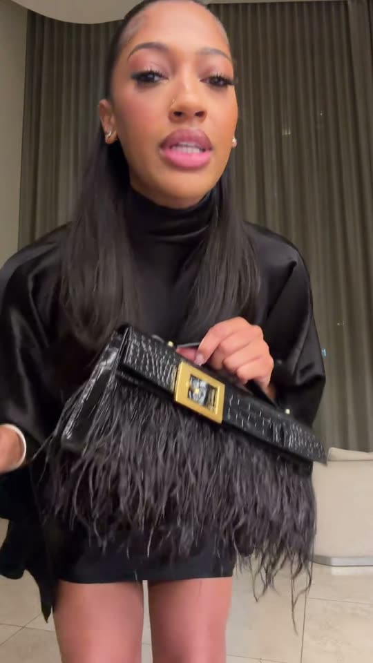 Woman shows off black purse