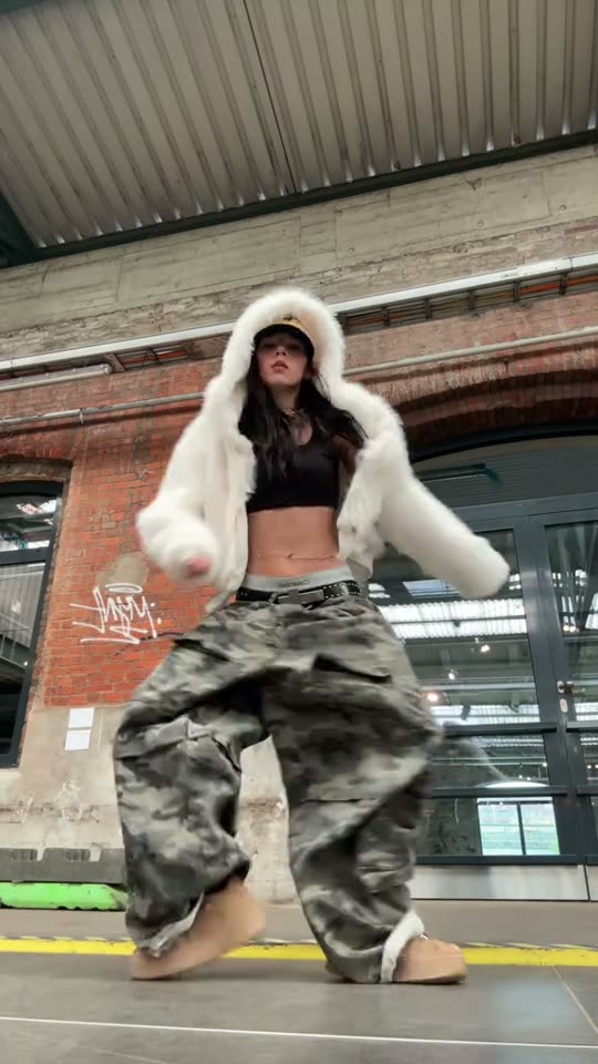 Woman dances in baggy clothes