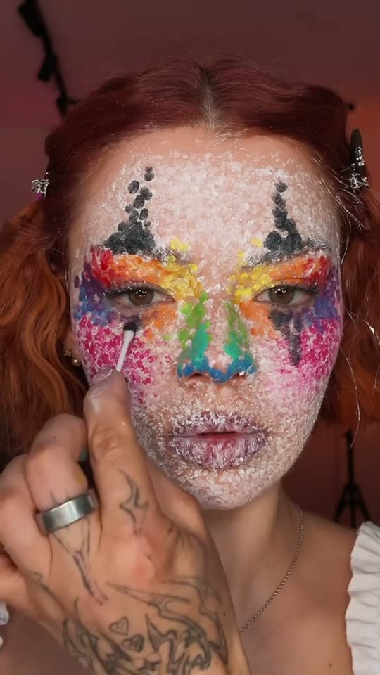 Applying colorful clown makeup